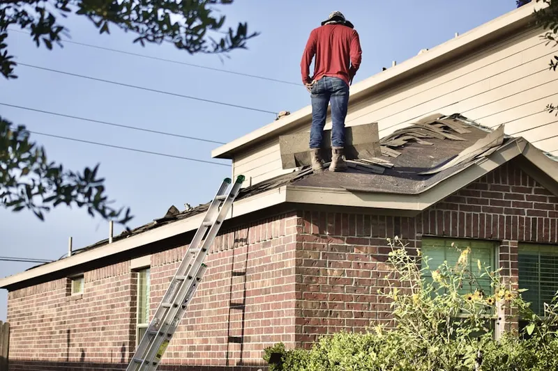 Professional roofer working on a residential roof in Downtown Kent